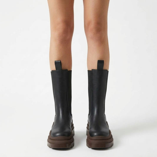 Black boots with brown sole, front view