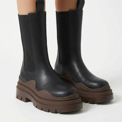 Black boots with brown sole, close-up detail