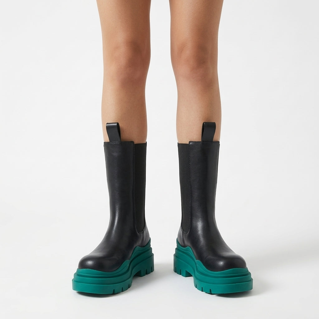 Black boots with green sole, front view