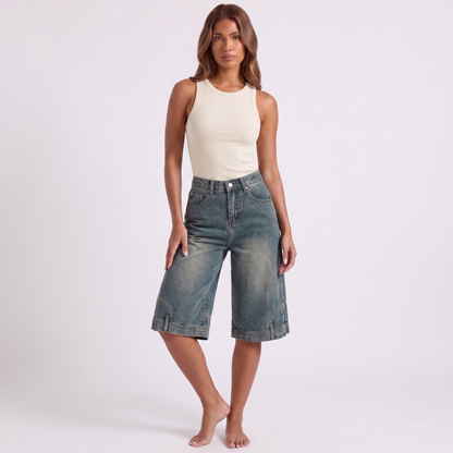 Retro high waist wide-leg knee-length denim shorts in washed blue-grey indigo - three-quarter angle showing the width and drape of the leg