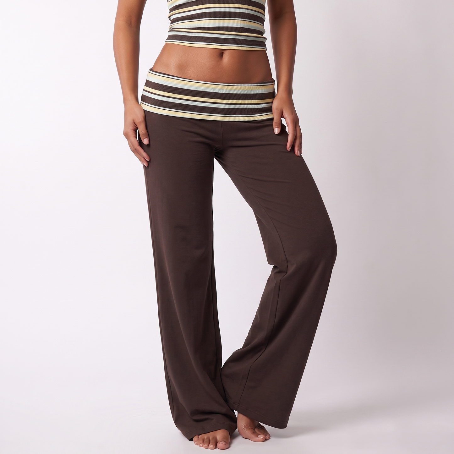 Low-rise fold-over striped waistband and full-length wide-leg brown trousers detail