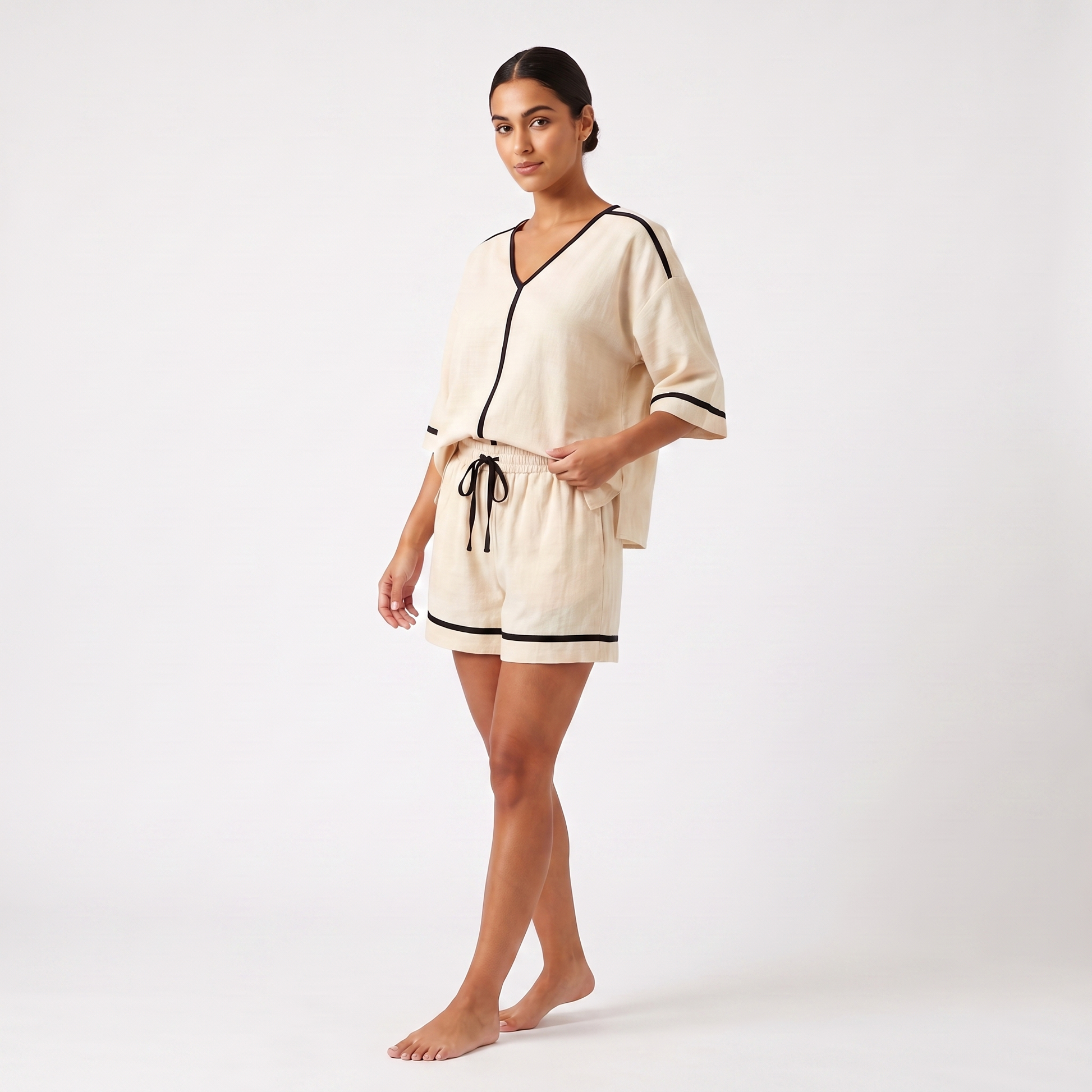 Three-quarter view showing the drape of the loose top and shorts