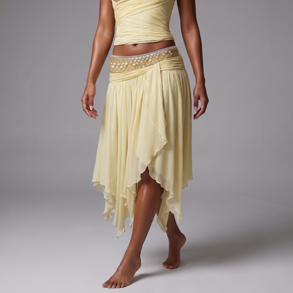 Close detail of the beaded low rise waistband and irregular handkerchief hem of the pale yellow chiffon skirt