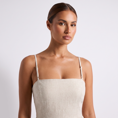 Casual Linen Romper in Apricot oatmeal linen - close detail of the bandeau neckline, showing the straight horizontal top edge, the flat un-shirred front panel and both thin self-fabric shoulder straps with their adjustable sliders.