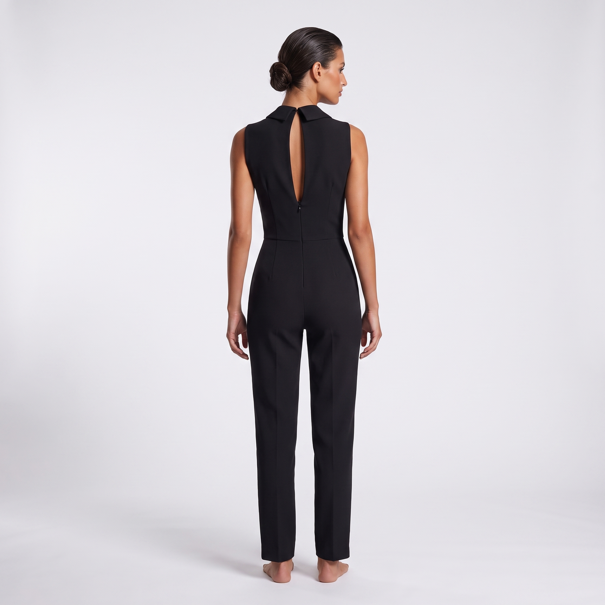 Black jumpsuit back view - standing collar tips, long centre-back keyhole slit and concealed zip