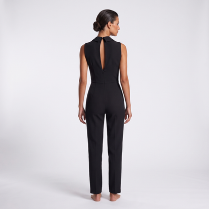 Black jumpsuit back view - standing collar tips, long centre-back keyhole slit and concealed zip