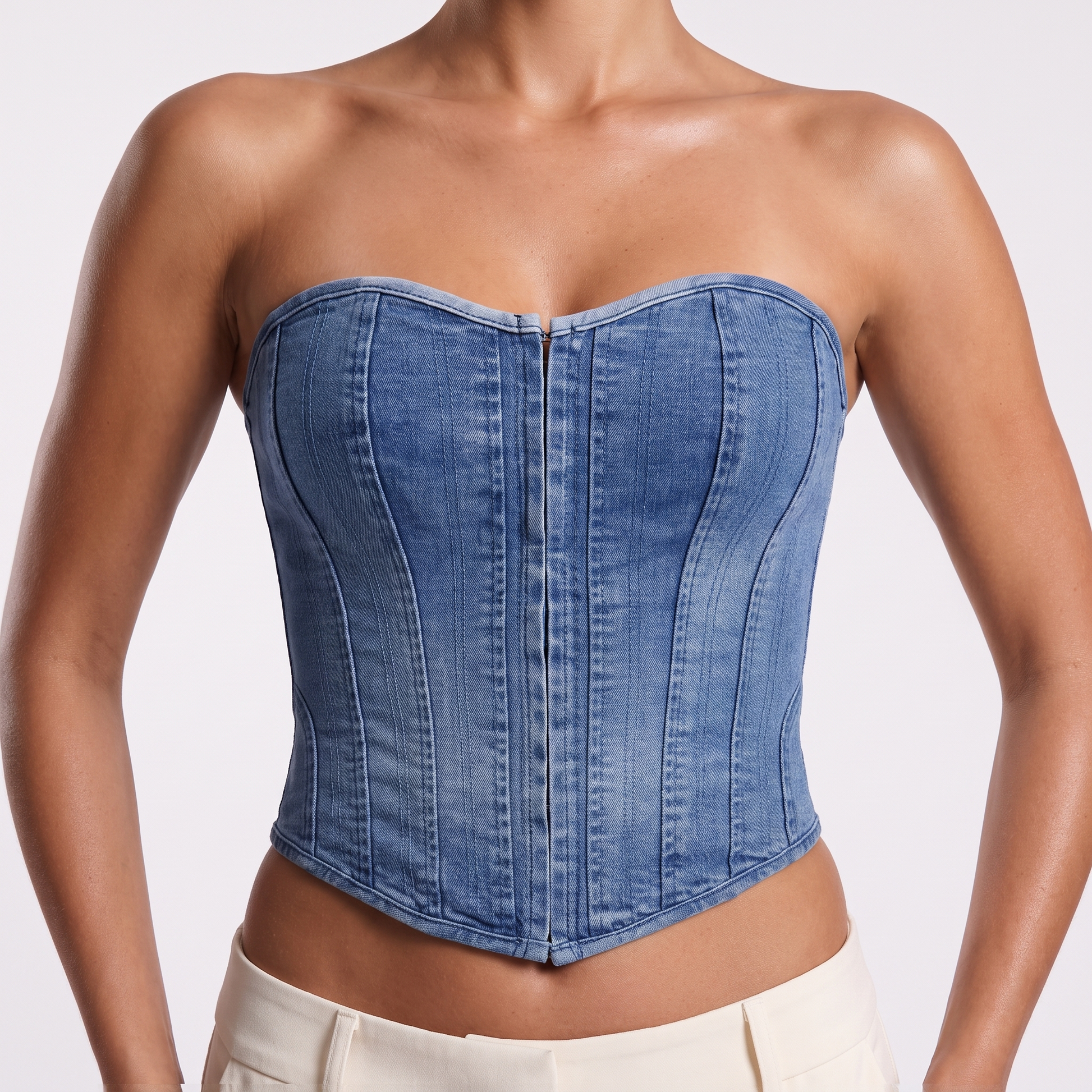 Denim corset vest front detail — sweetheart neckline, vertical boning seams and concealed centre-front closure with hook