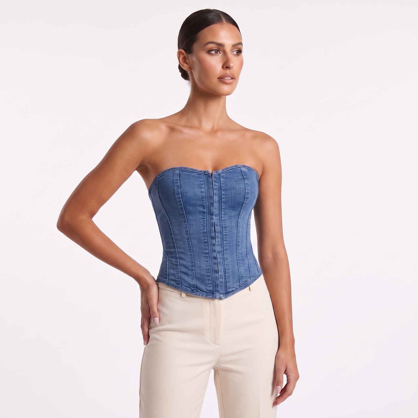 Denim corset vest three-quarter view showing moulded corset shape and washed indigo denim