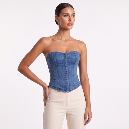 Denim corset vest three-quarter view showing moulded corset shape and washed indigo denim