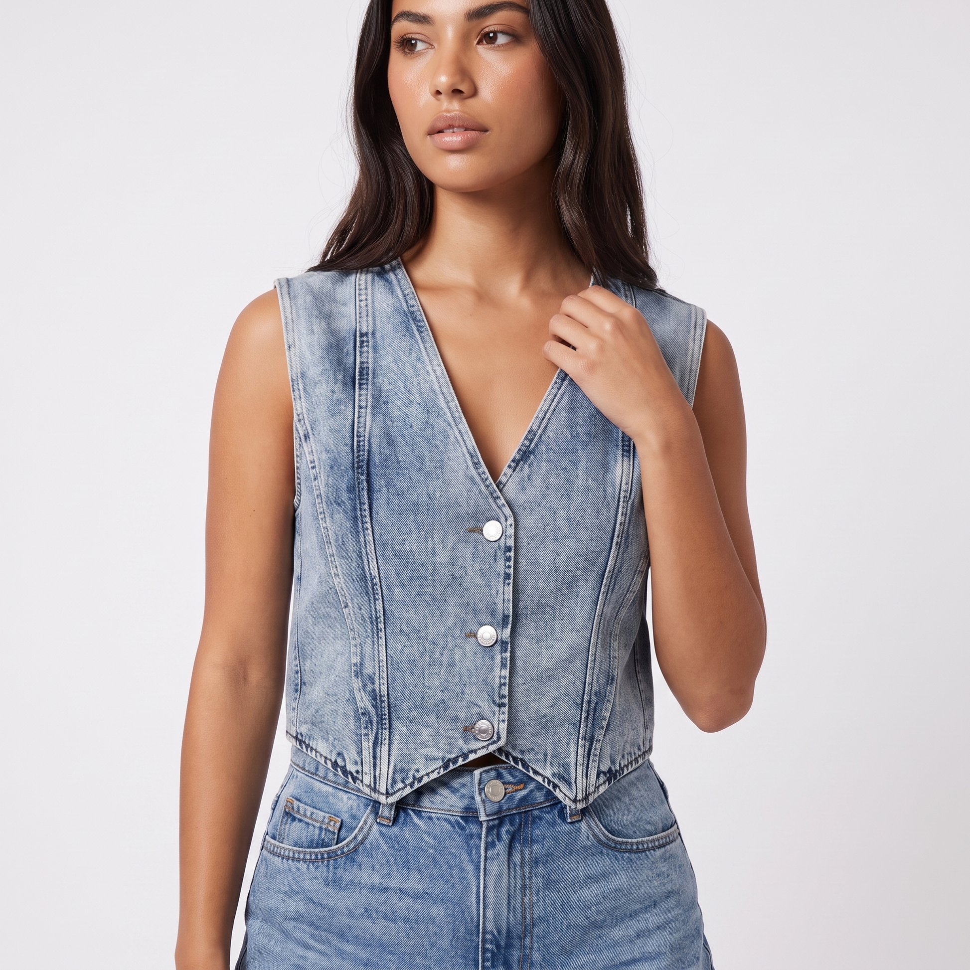 Acid-wash denim vest - detail, deep V neckline with darker denim collar binding, three silver buttons, cropped pointed hem