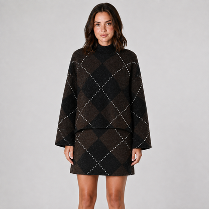 Model wearing the matching dark brown and black argyle mock-neck knit top and mini skirt, front view.