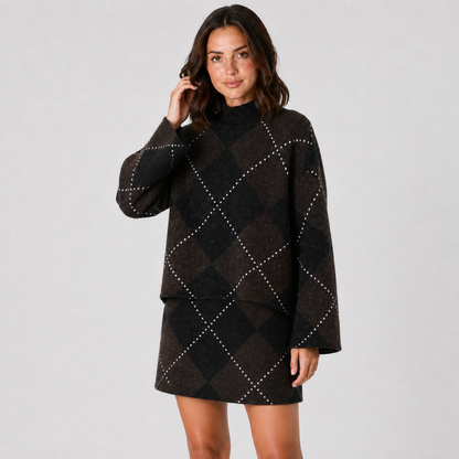 Model wearing the matching dark brown and black argyle mock-neck knit top and mini skirt, three-quarter view.