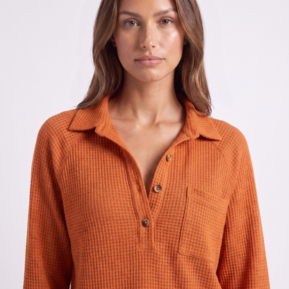Johnny collar, three-button placket and chest pocket detail