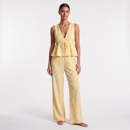 Yellow striped sleeveless V-neck peplum top and wide-leg trouser set, full-length front view