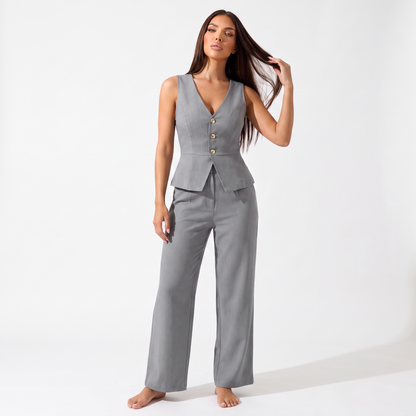 Grey sleeveless V-neck peplum vest and high-waisted wide-leg trouser set, full-length front view